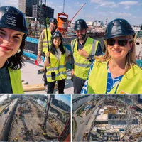 Group of people with yellow safety vests and helmets, on a museum construction site